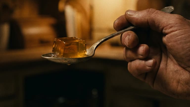 Amber gelatin cube on a spoon